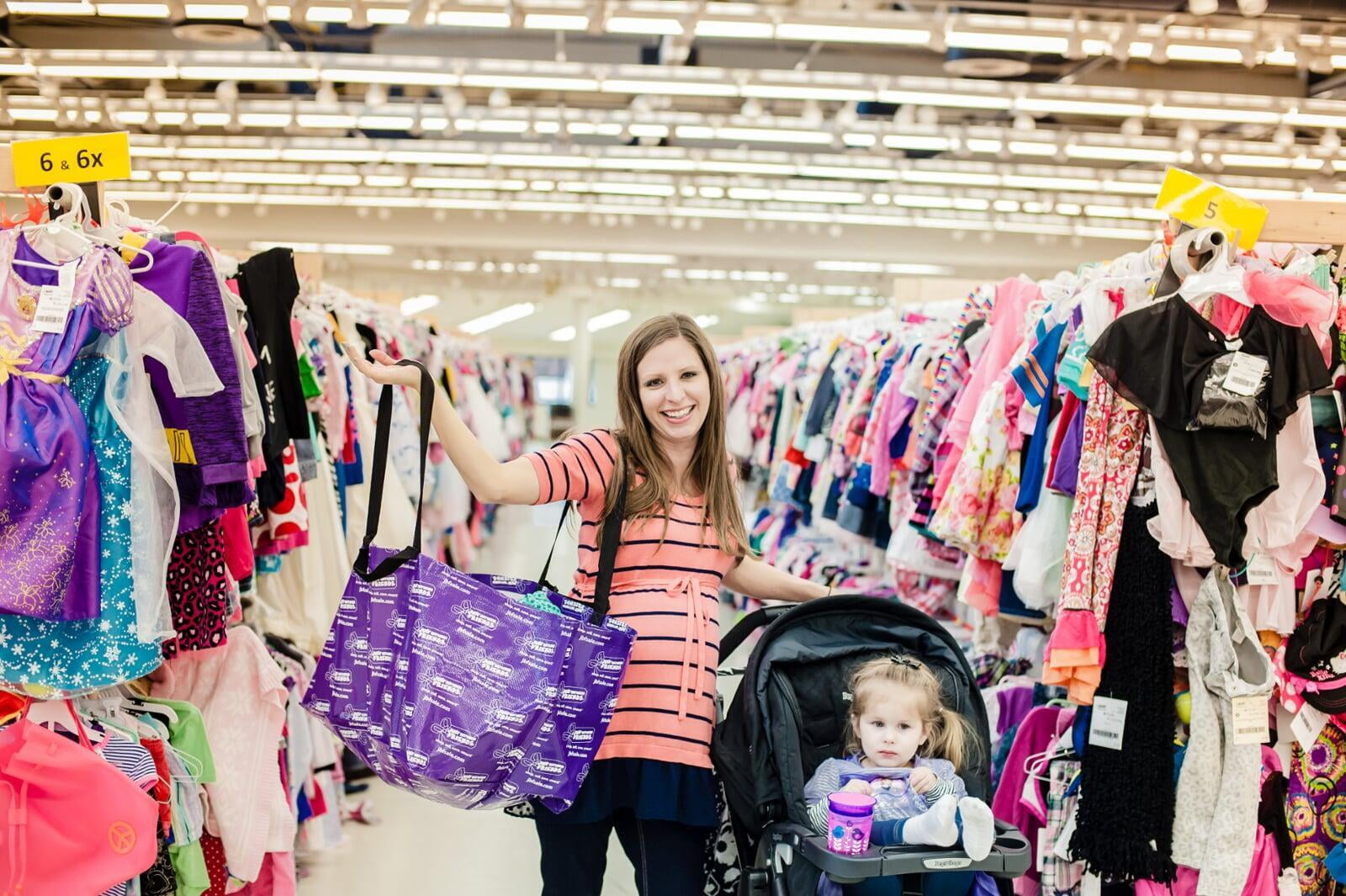 Two friends shop together—one mom wears her baby girl—as they find great deals at their local JBF sale.